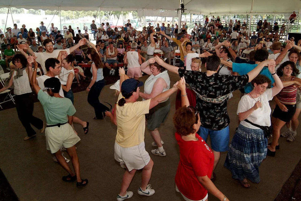 Couples dancing in a village hall at a ceilidh