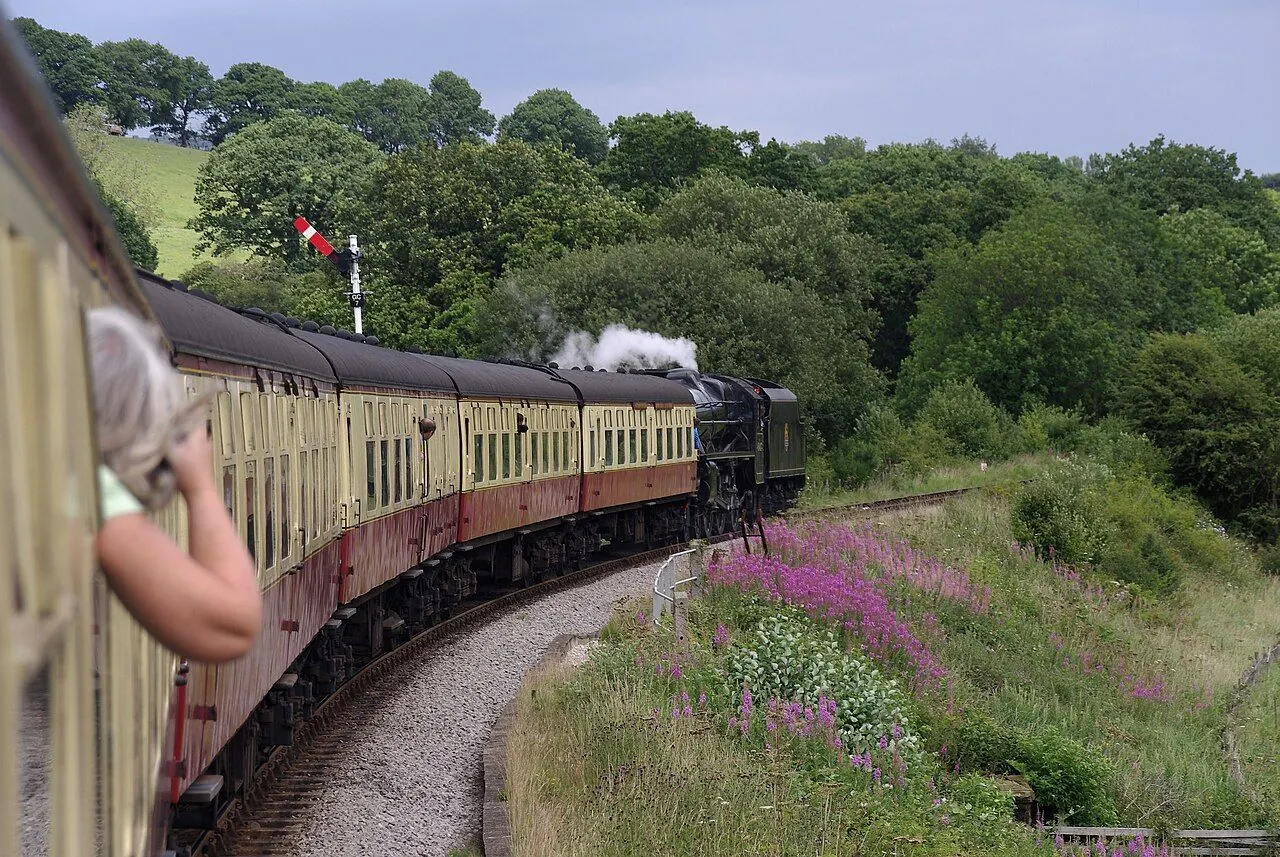 Steam train crossing heather moorland in Newton Dale
